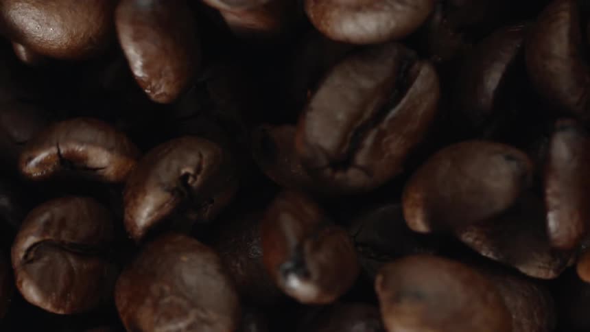 Close up of coffee beans vibrating in a pile