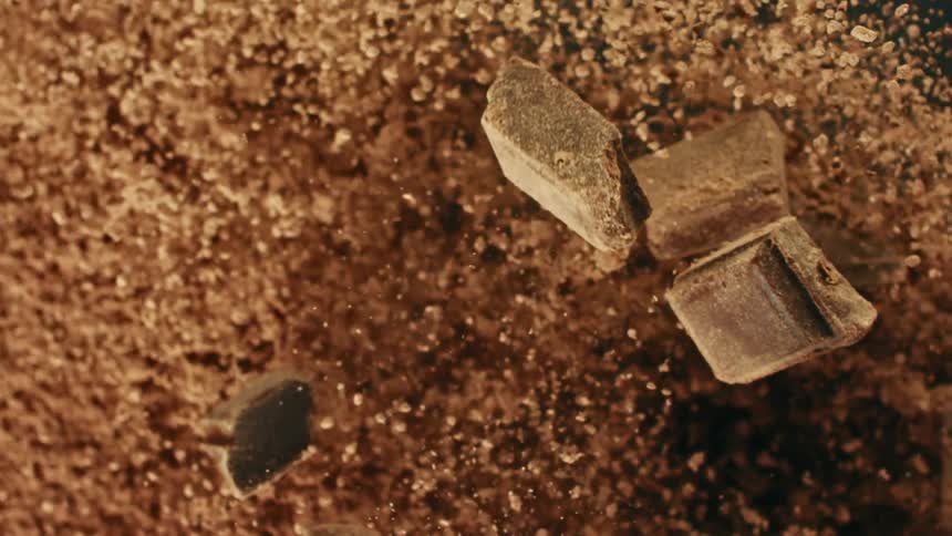 Pieces of chocolate and powder fly through the air