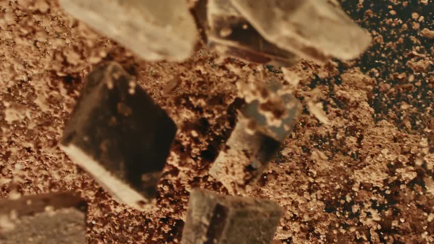Pieces of chocolate and powder fly through the air