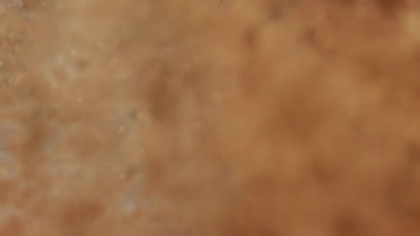 Brown orange and gray shapes and colors that look like dust fire and smoke