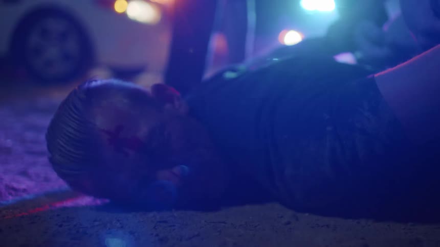 Police hand cuff a man they have down on the ground