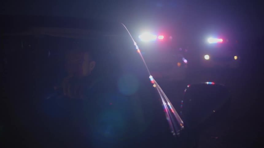 A person is pulled over with multiple police vehicles behind