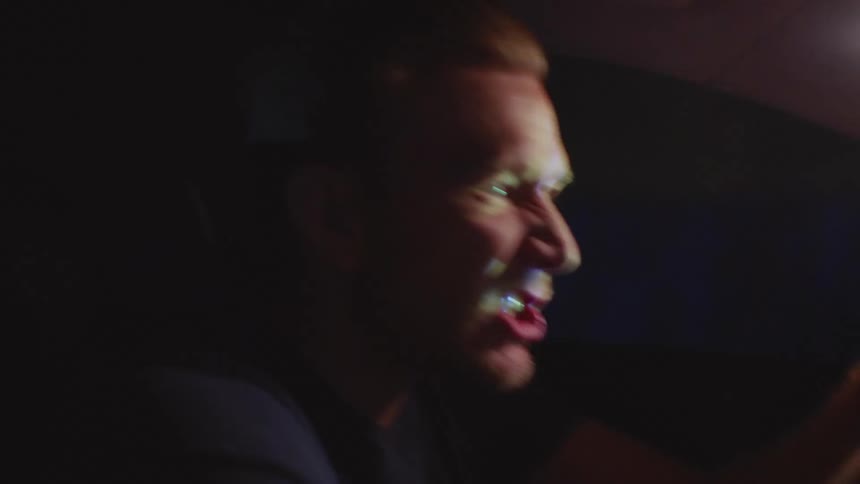 Angry man drives a vehicle at night