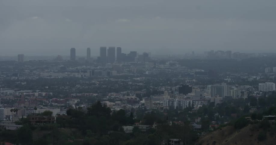 The city below has heavy fog around it