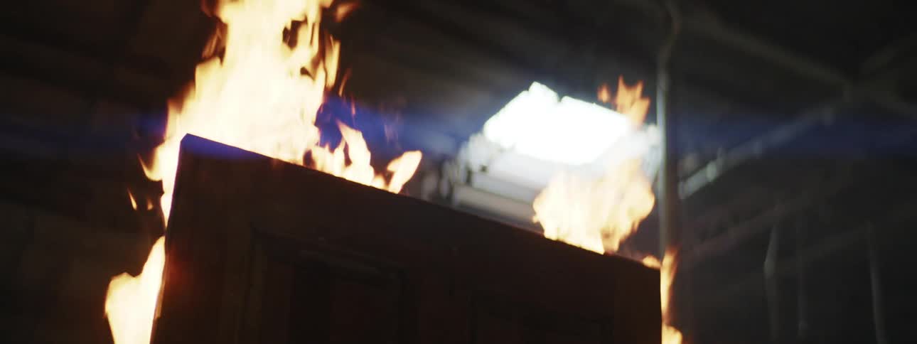 A piece of wood is on fire indoors