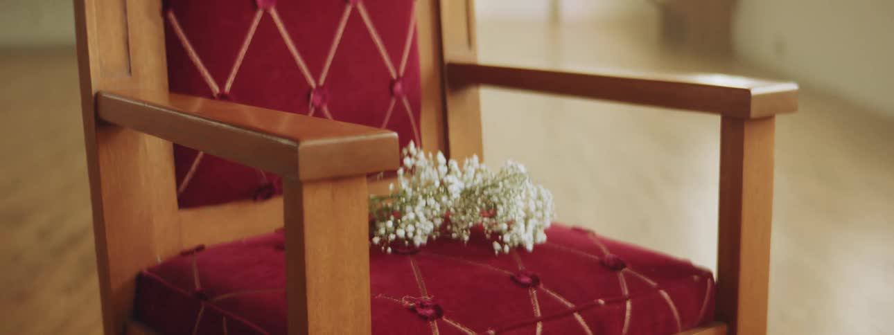 Flowers are sitting on the red chair