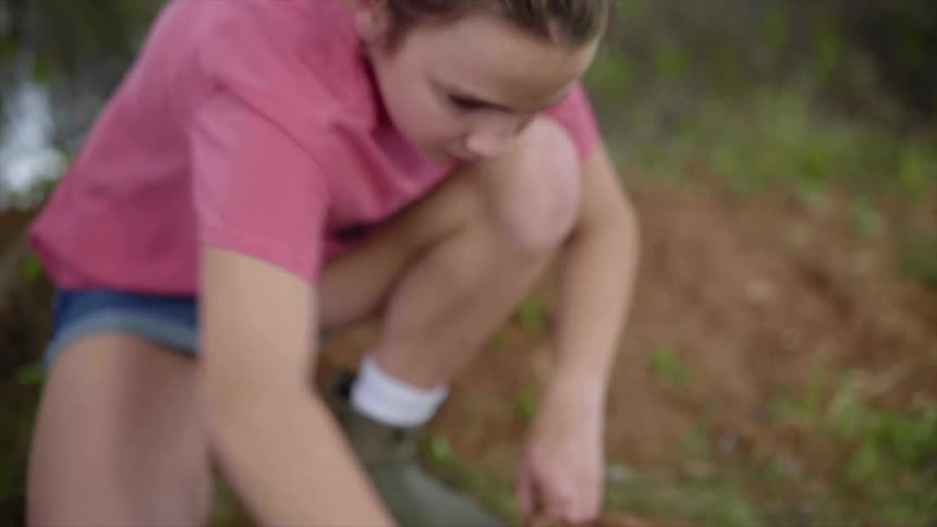 A girl lifts her backpack and goes for a hike
