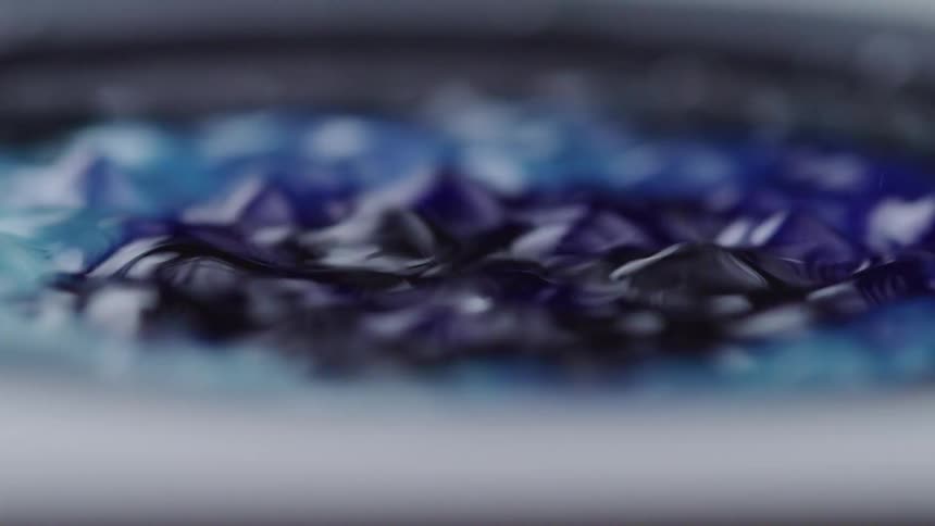 Droplets splash into the liquid below