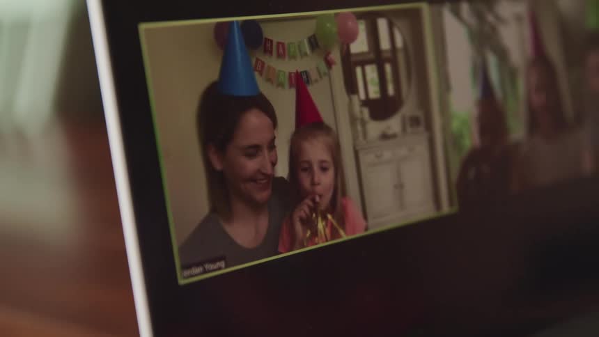 Mother and daughter celebrate a birthday on a video call in a laptop screen