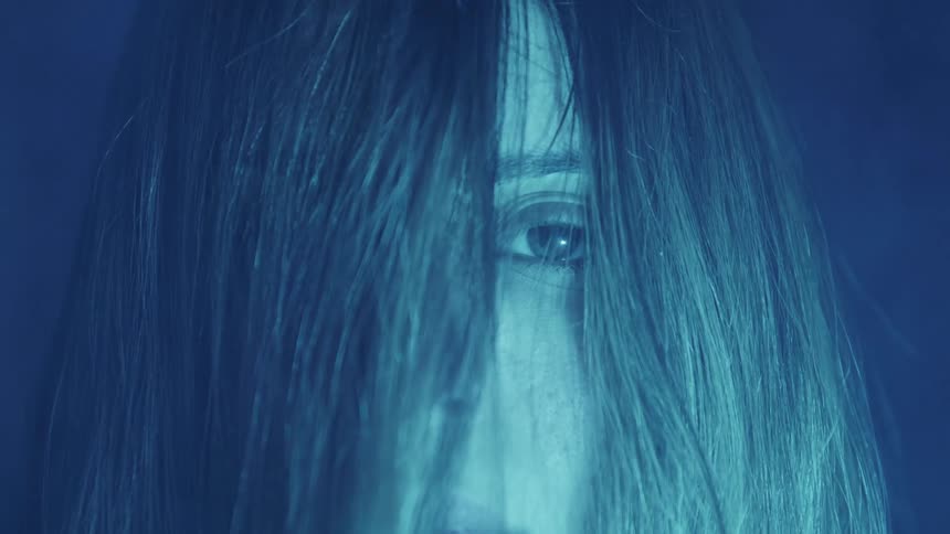 A closeup of a womans face is displayed