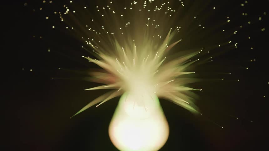 A fiber optic lamp spins around flashing colors