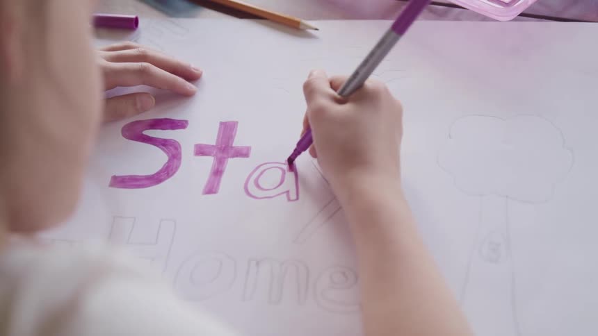 A child is drawing a sign