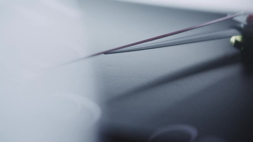 An exceptionally close view of the face of an elegant timepiece that has its seconds hand moving slowly