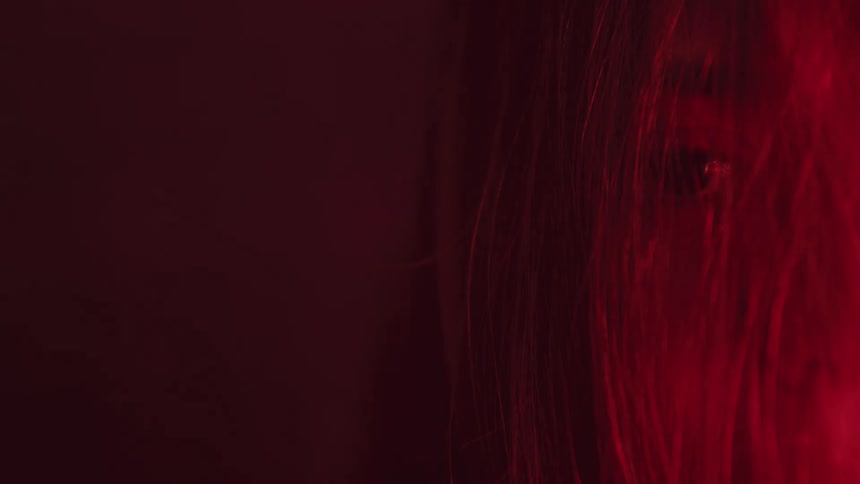 A closeup of a womans face is displayed