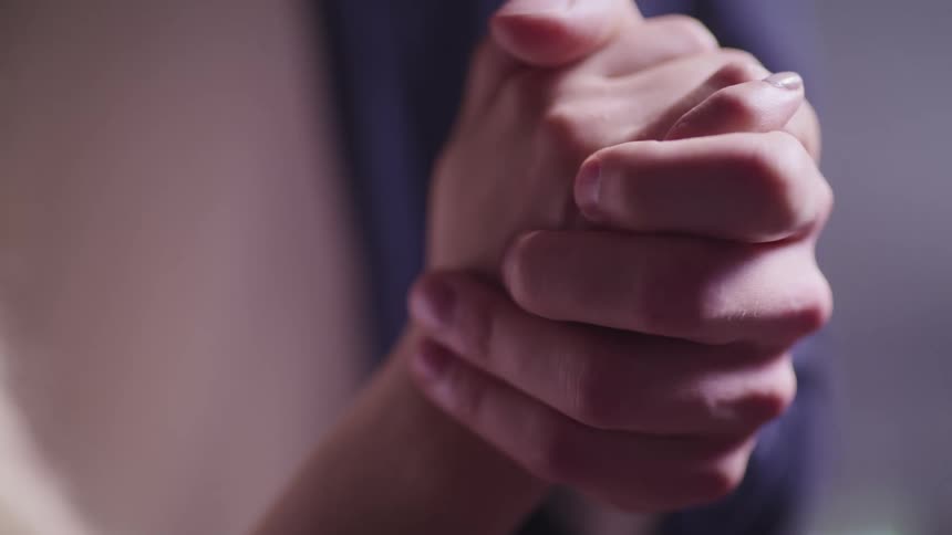 Two hands clasped together