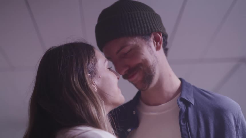 A man and woman dance closely together