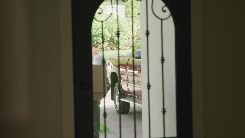 Man delivers groceries setting box near door