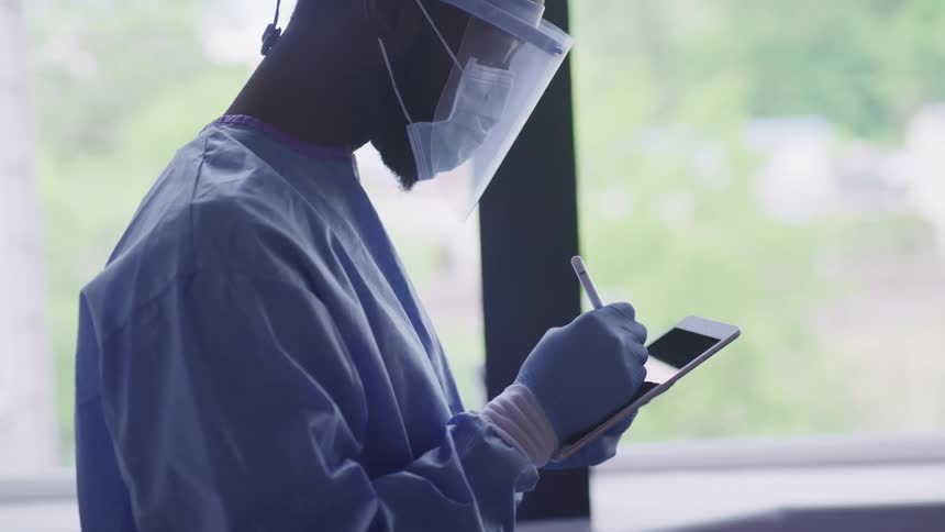 A doctor is using a tablet in a hospital