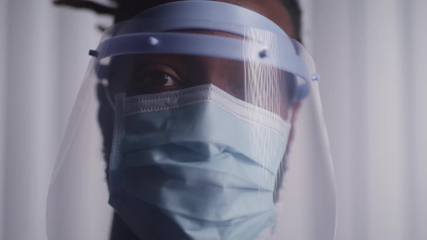 A doctor is wearing a face mask indoors