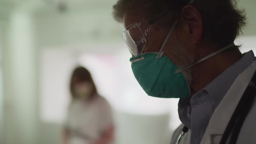A doctor is in the room with a patient