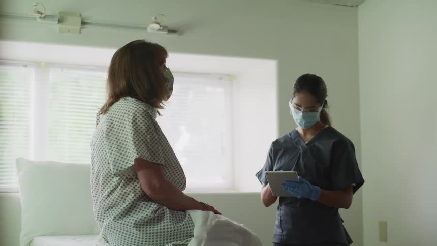 A patient talks with a nurse in a clinic