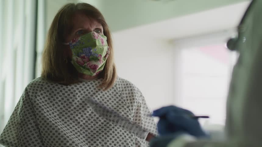 A patient in a clinic talks with a nurse