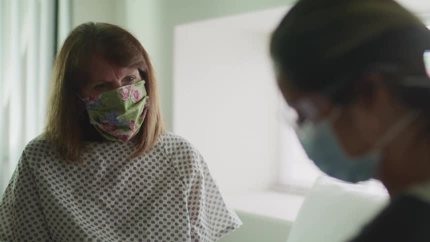 A patient talks with a nurse at a clinic