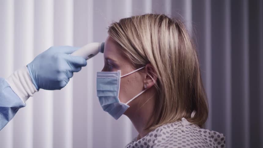 A doctor uses a medical device on a woman