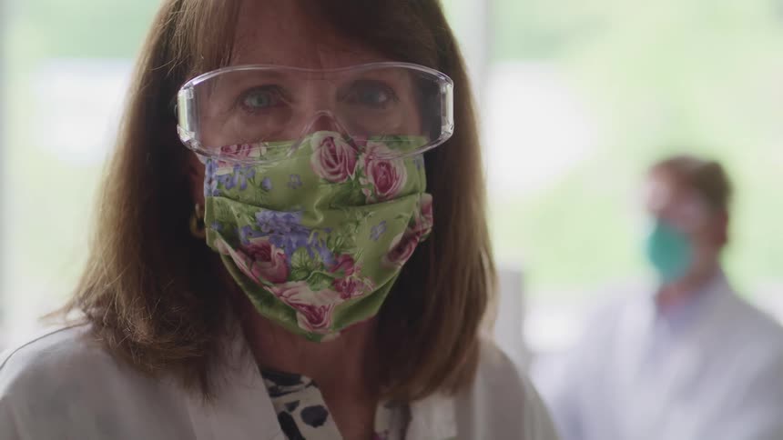 A doctor is wearing glasses and a face mask