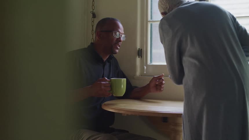 Mother serves hot beverages for herself and her son in at home