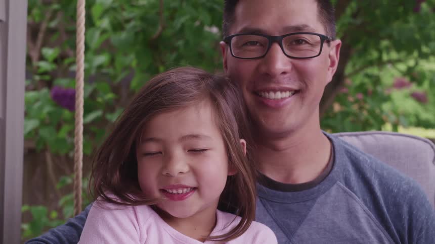 A little girl and her dad pose for a photo