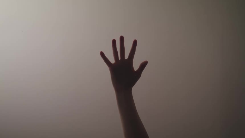 A person is reaching up with their hand