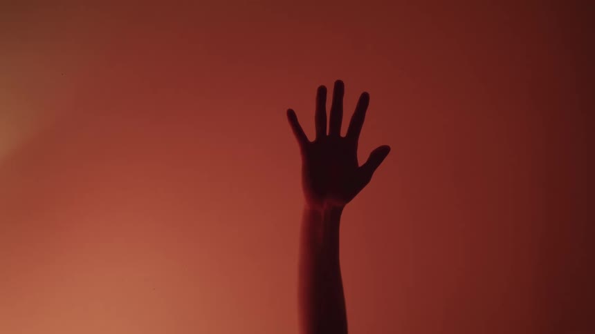 An arm reaches up and then slides back down