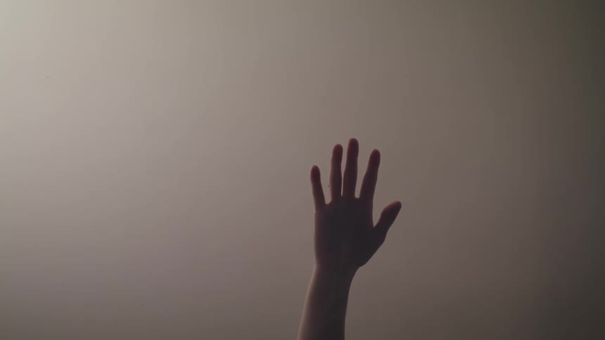 A person reaches up before sliding down