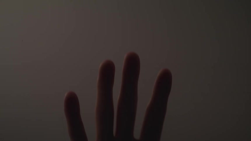 A persons hand moving down