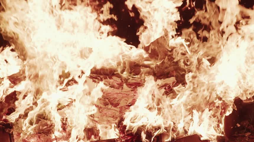 A fire burning with smoke embers and ash