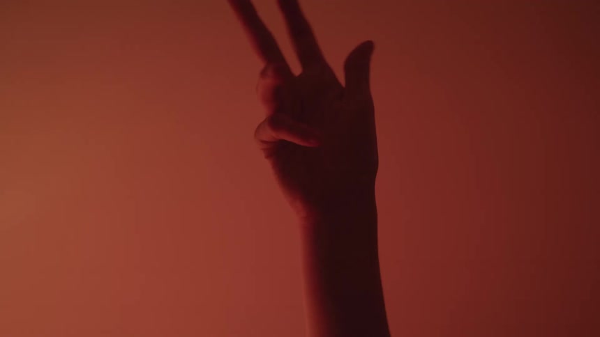 A hand reaches up and moves around