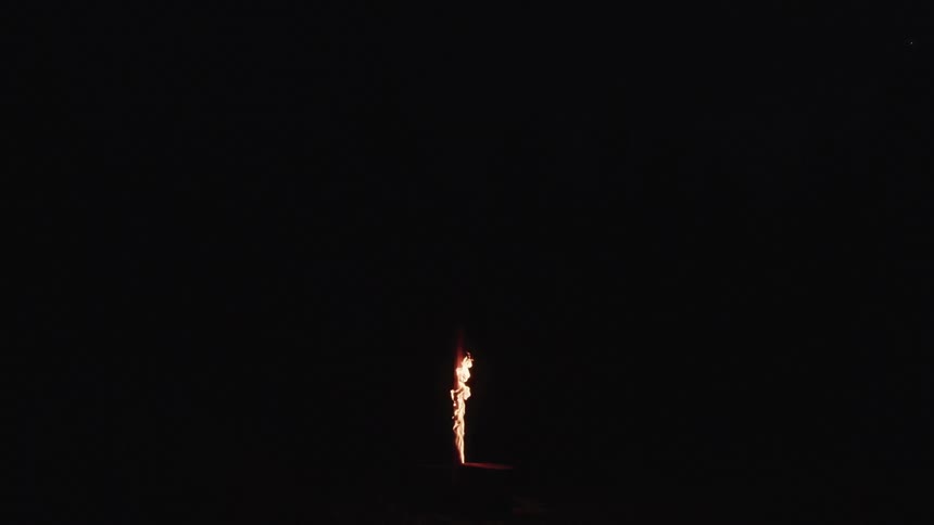 Flames burning outside at night