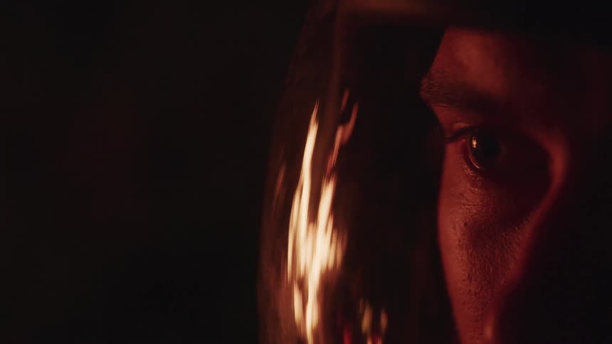 Flames burn next to a mans head