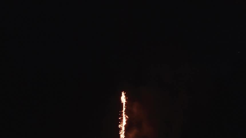 A pole burns in the middle of the night