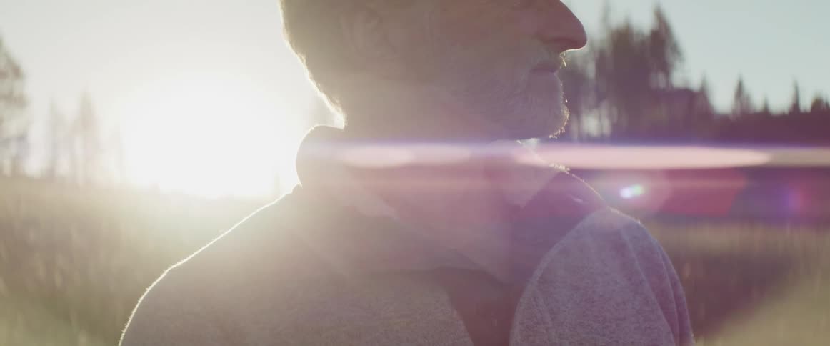 A man standing outside and looking off in to the distance