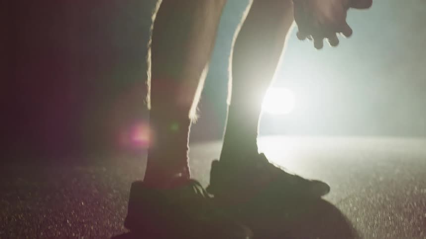 A man is standing outdoors in workout clothes