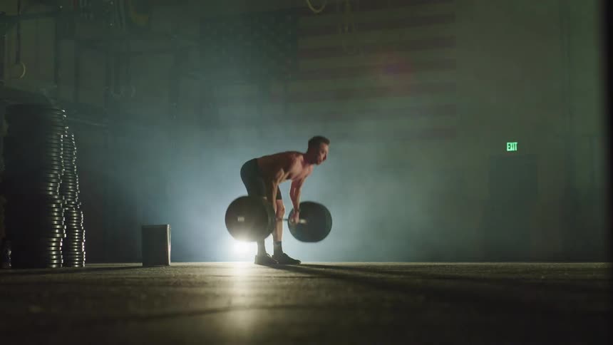 A man is lifting weights in the gym