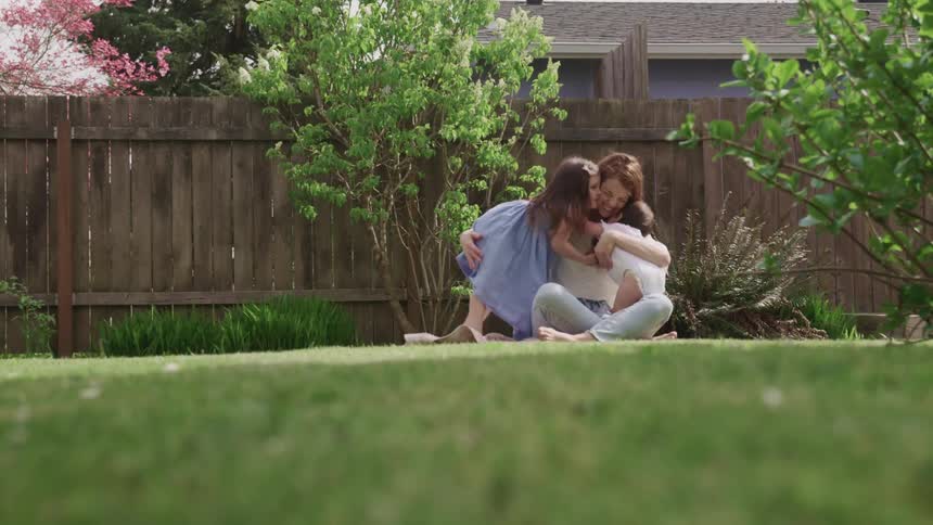 A family hug and play in the yard
