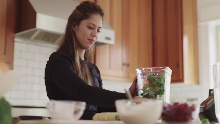 A woman is preparing food in the kitchen