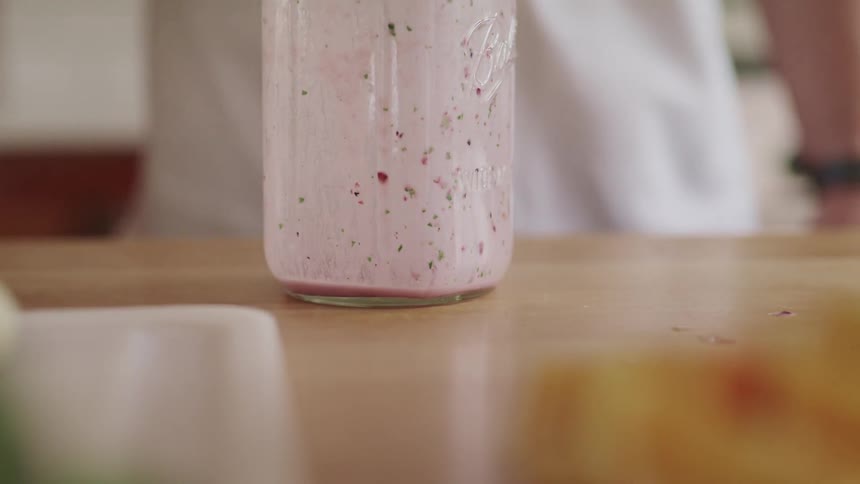 A person places a glass on the table