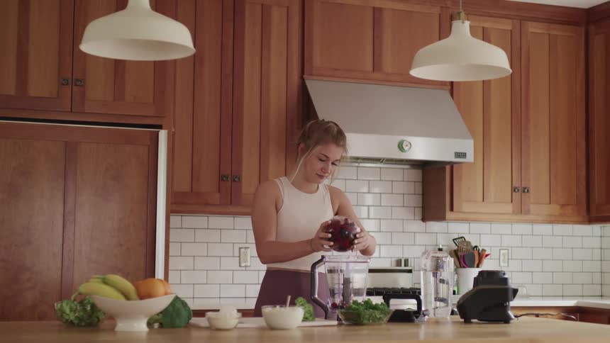 A woman is preparing food in a kitchen