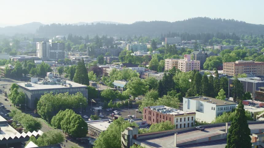 Aerial view of a small city near the mountains at sunrise