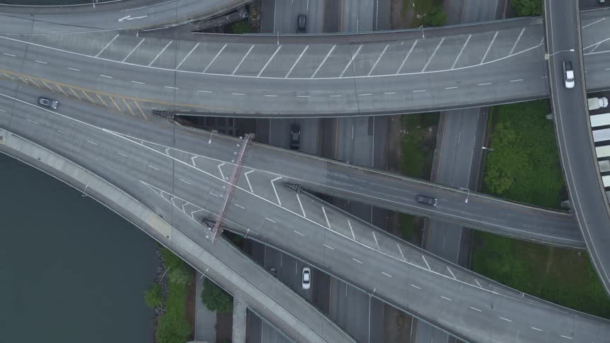 The vehicles travel on the winding roads below