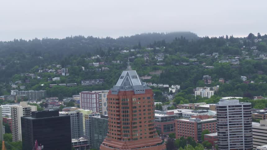 The tall builds are by the hills covered with fog